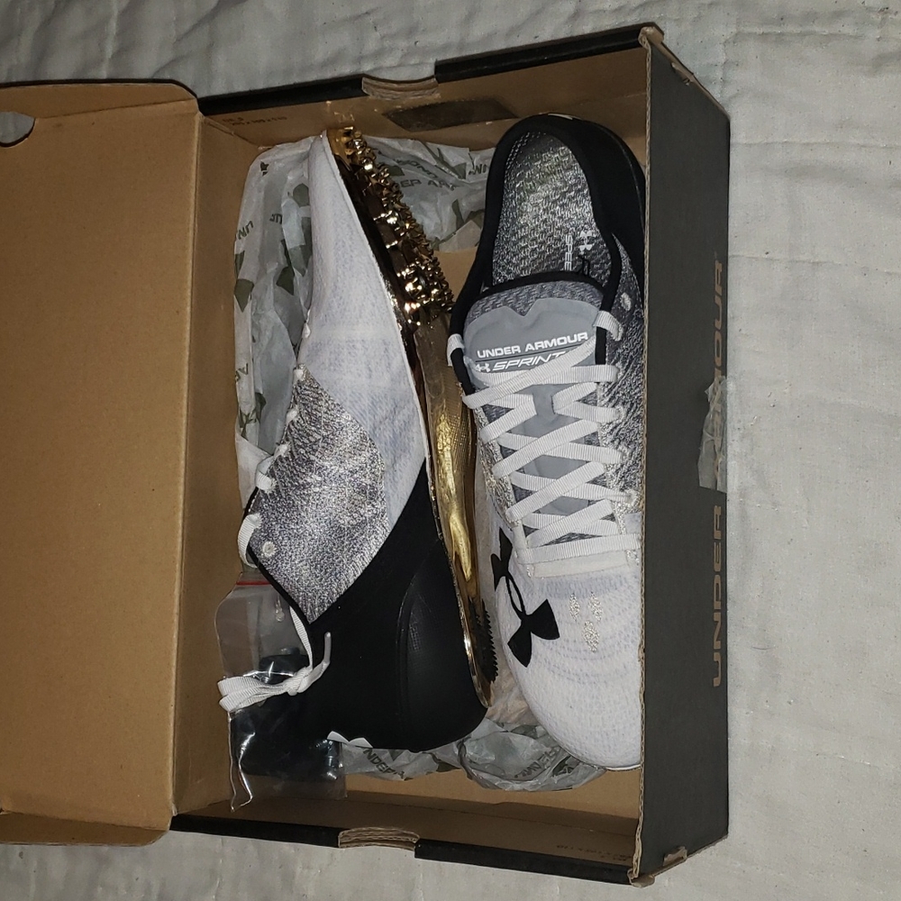 Under armour black, white, grey, and gold track shoes with spikes new in box